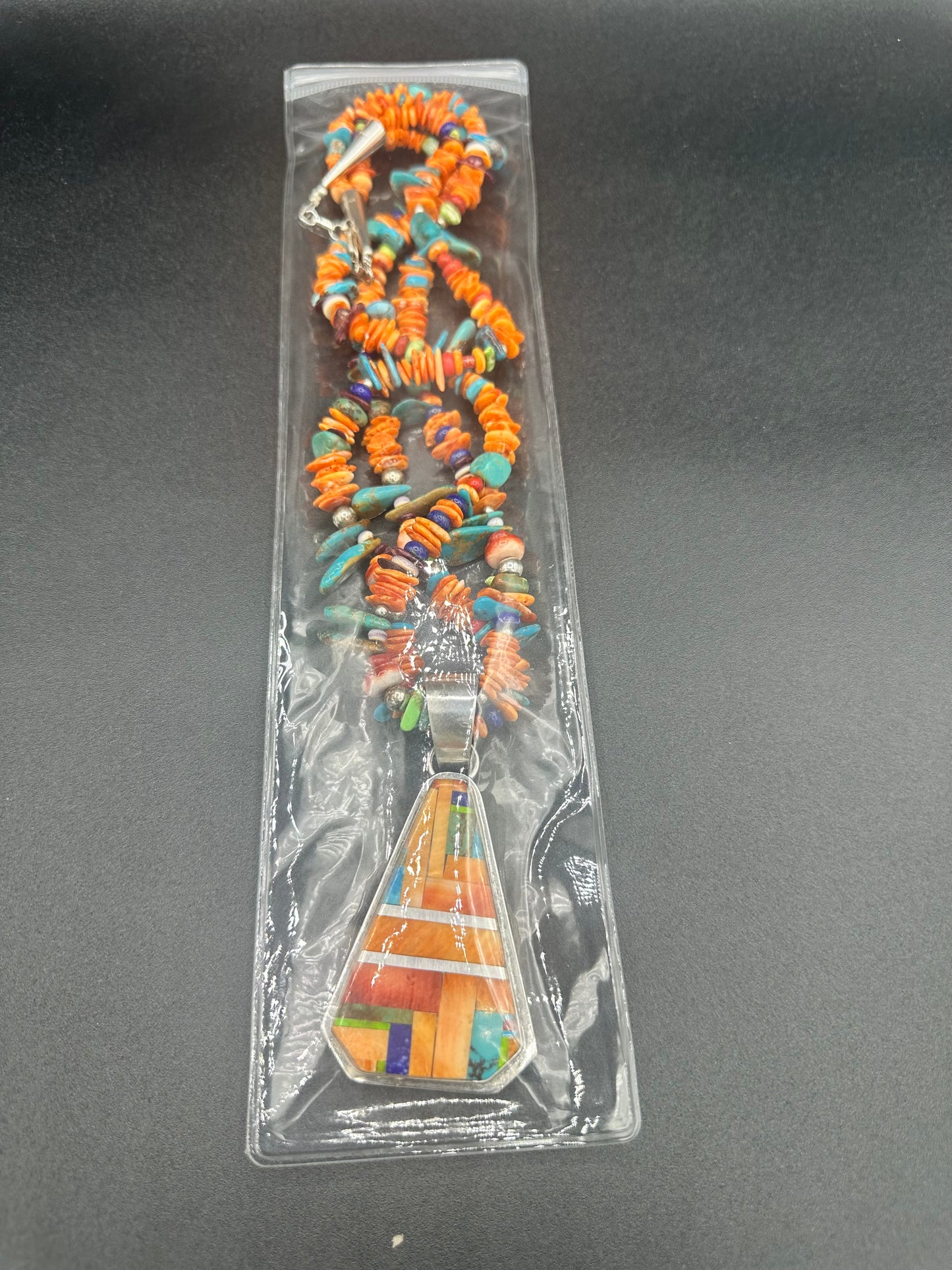 Handcrafted Native American sterling silver and multi-gemstone necklace and pendant.
